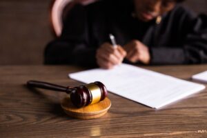gavel on stand and person writing